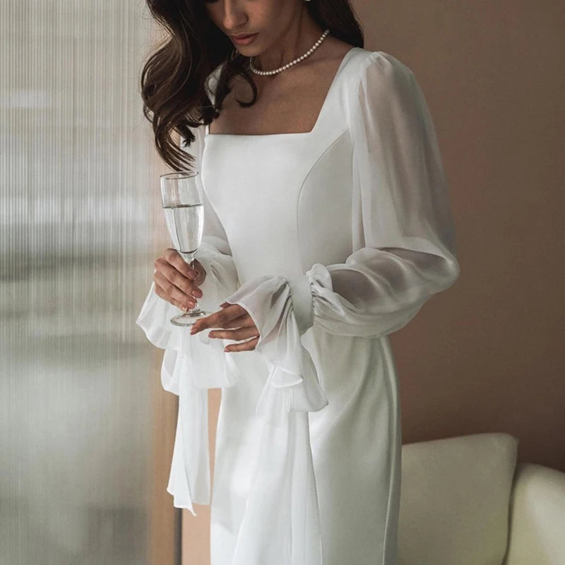 Elegant white dress with transparent sleeves